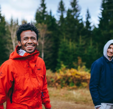 To smilende menn går tur i skogen