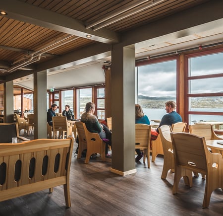 Personer som sitter i en sitter på stoler rundt et bord