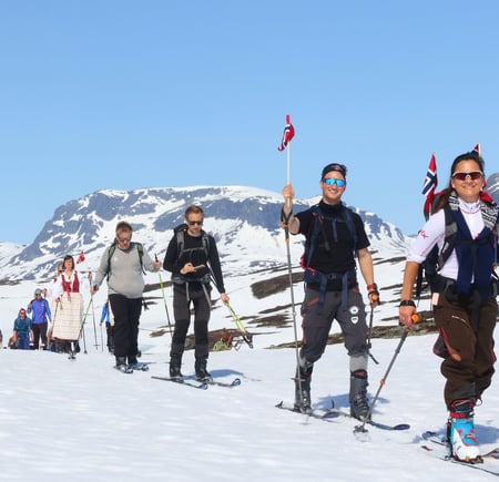 skigåere med bunad og flagg