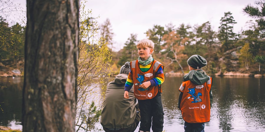To barn leker i vannet i skogen