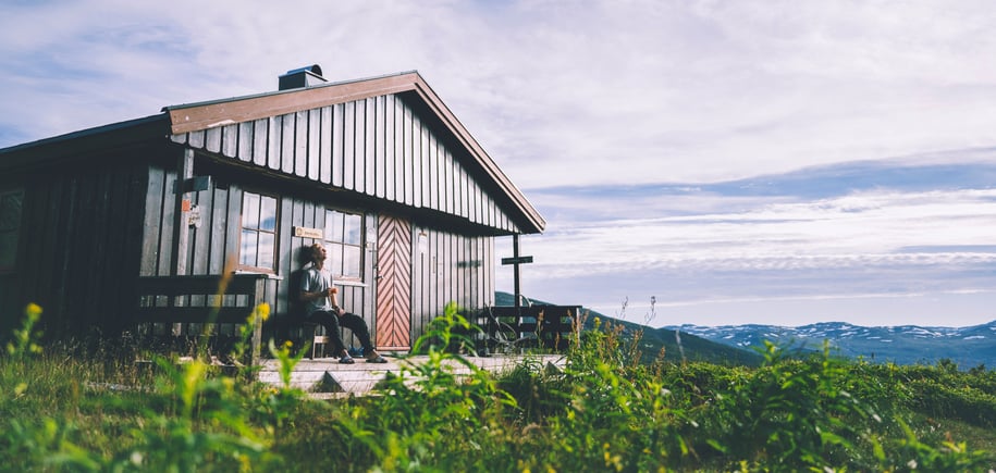 Brun hytte i grønne omgivelser