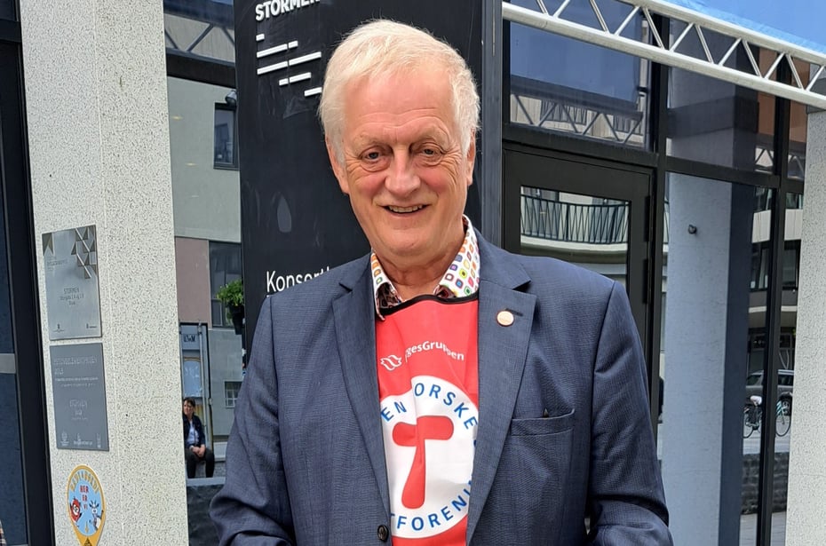 Mann med hvitt hår, DNT-ambassadørvest og dressjakke