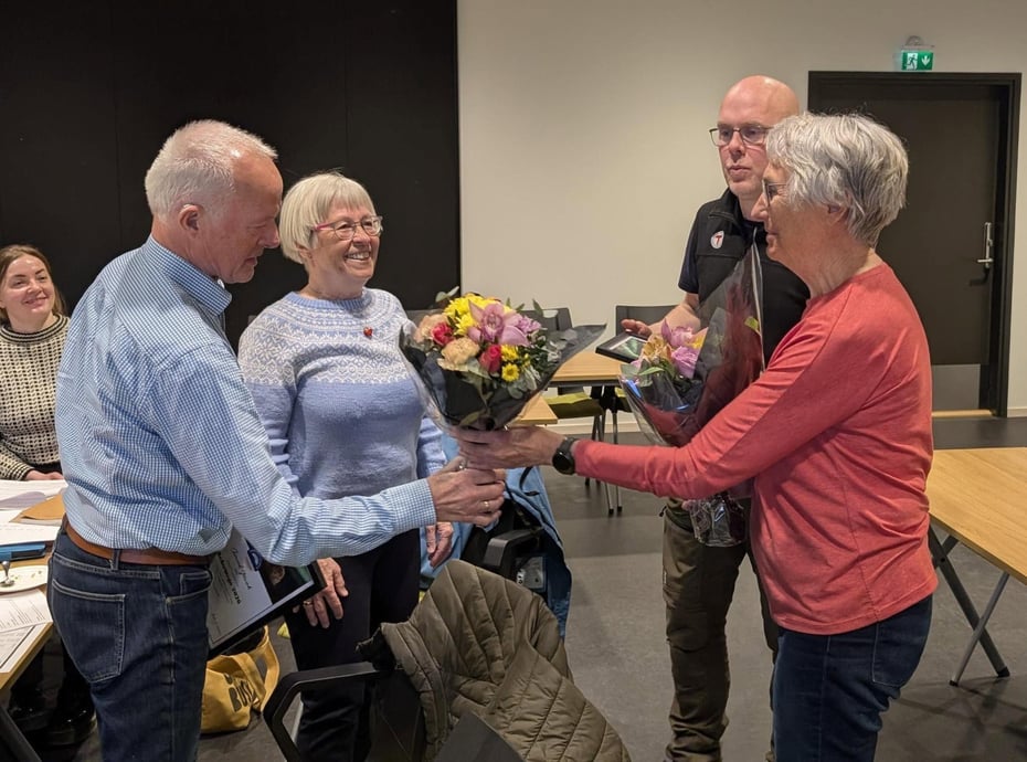 To st som tar imot blomster og flirer
