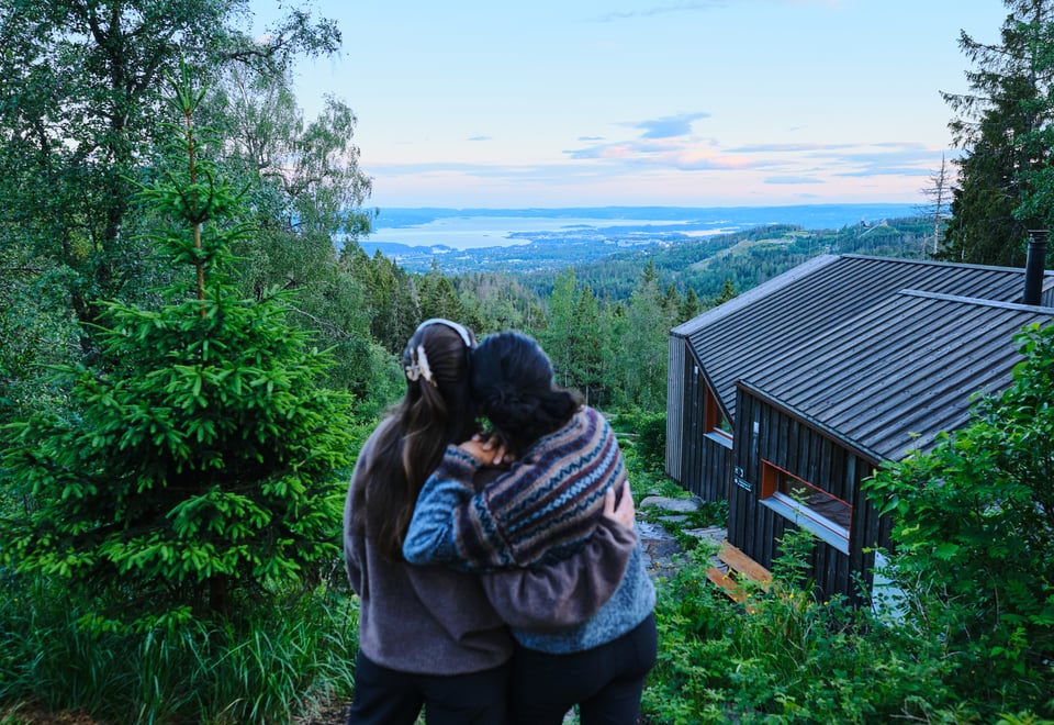 to personer står og se på utsikt ved DNT-hytte