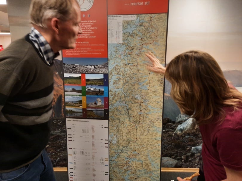 En mann og ei dame studerer kartet over Nordlandsruta