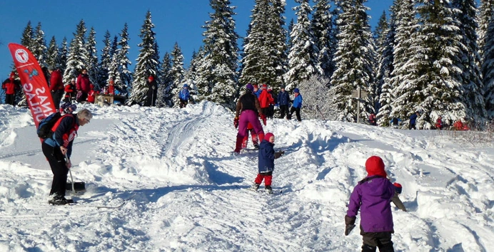 Barn leker på ski i akebakke