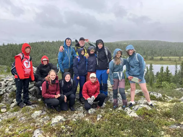 Ungdomsgjeng på tur ved fjellvann.