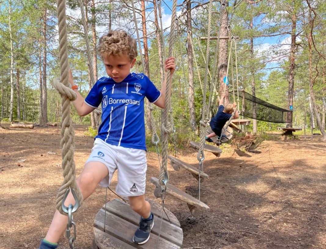 gutt klatrer i klatrel&oslash;ype i skogen