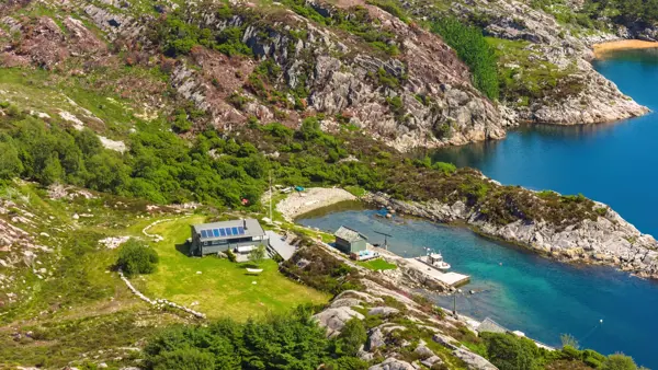 Dronefoto av hytte ved sjøen
