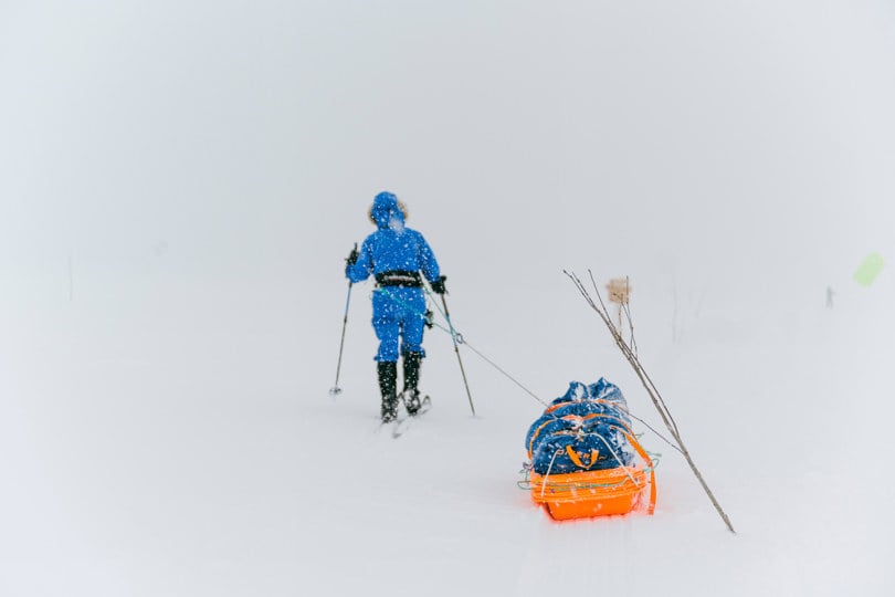 Turgåer med pulk i snødrev