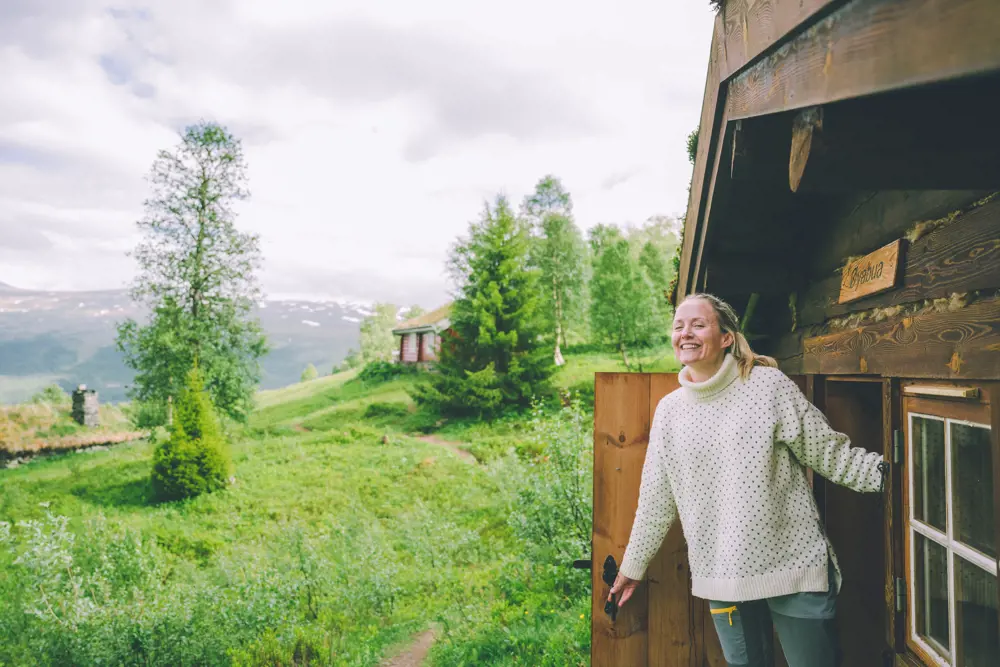 A woman opening a door in a cabin