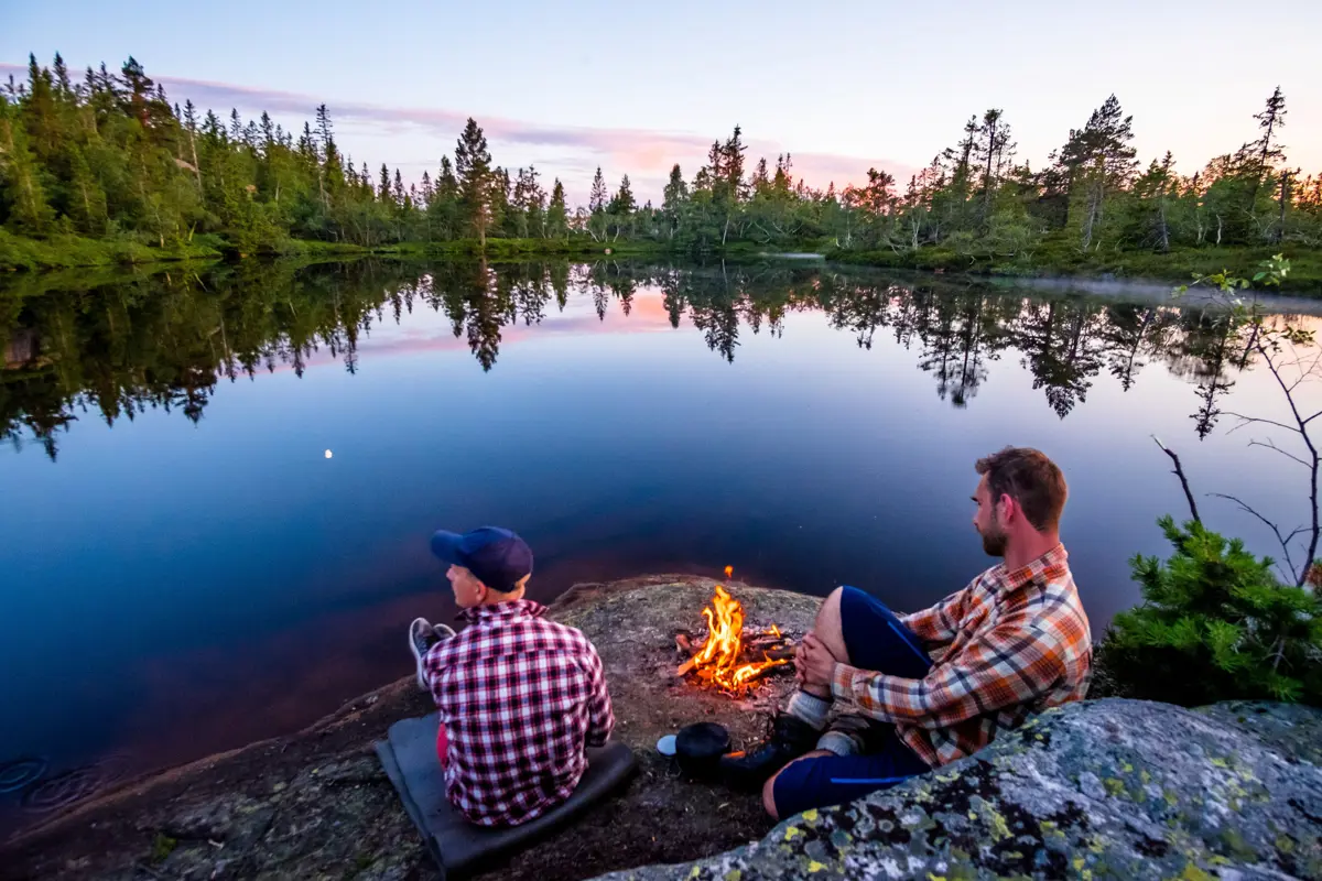 Telttur i Austheiene, ved Skarsvassbu i Åmli. Bål, telt, blikkstille vann. Skog, utsikt.