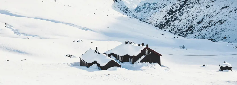 Svartmalt hytte begravet i snøen